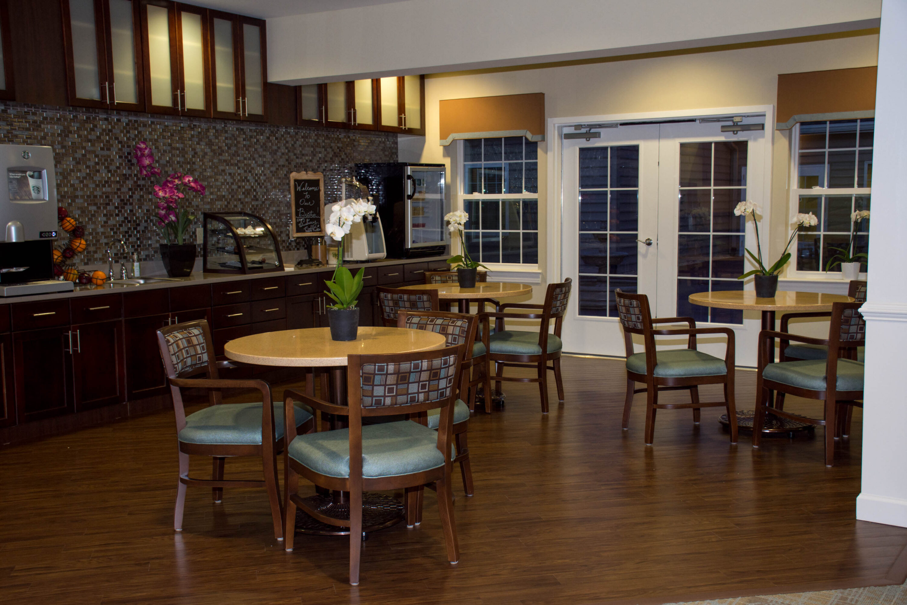 Cozy café-style kitchen with round tables and orchids